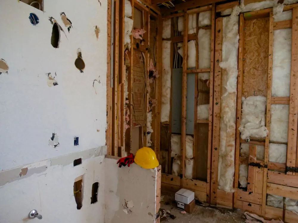A Blouin Brothers team member installing insulation in a home.