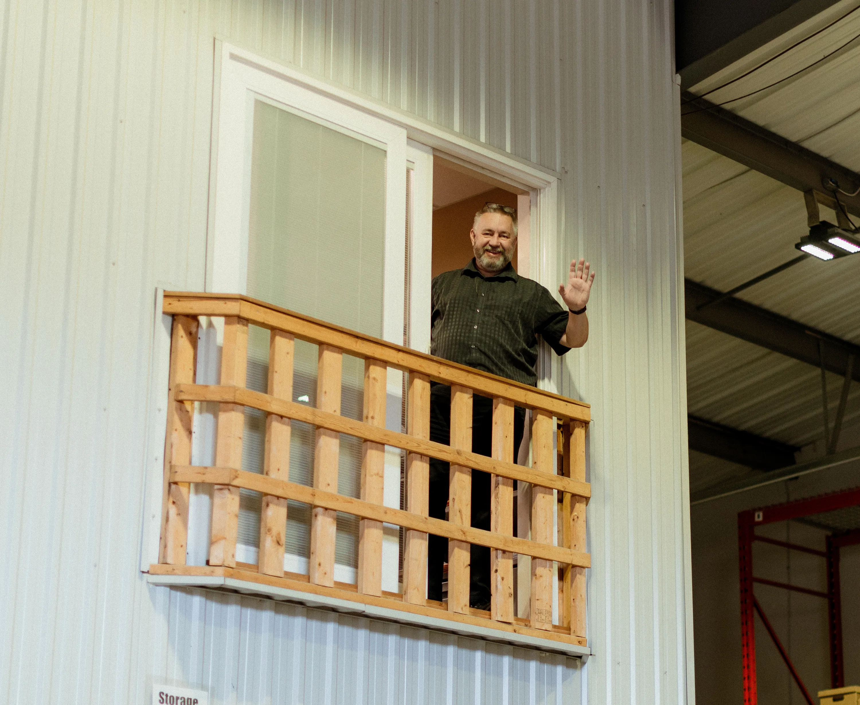 Paul Murphy, General Manager of Blouin Brothers Insulation smiles from a second floor balcony.